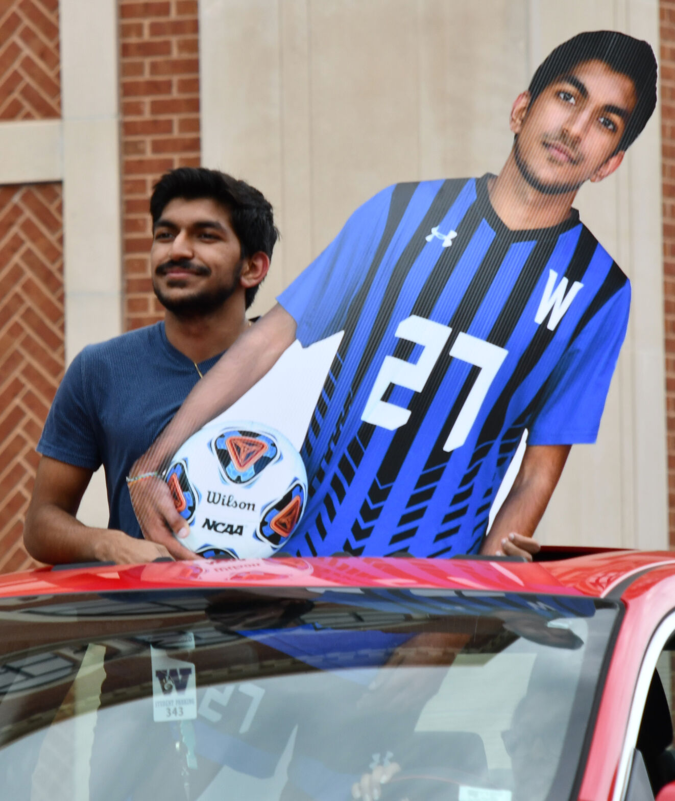 Harsh Patel stand with a cutout
